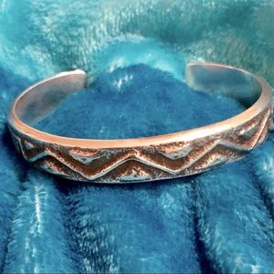 Silver cuff bracelet with etched tribal pattern
